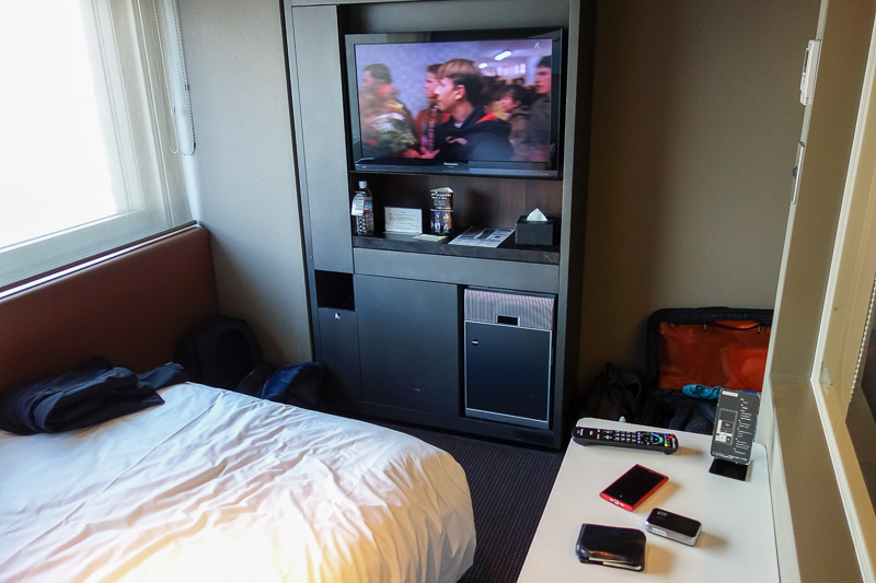 Hong Kong - Japan - Taiwan - March 2014 - The tv and fridge are built into the wall. Dead poets society is on, in English.