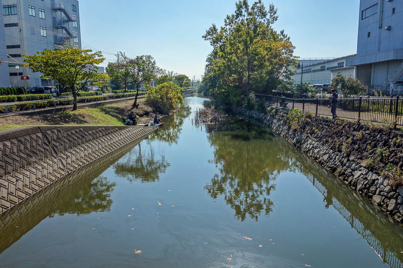 Japan-Tokyo-Mall-Koshigaya-Aeon Lake - One of the open drains in the industrial area, except theres guys fishing down there. The water is very shiny! I hope they arent planning to eat anyth