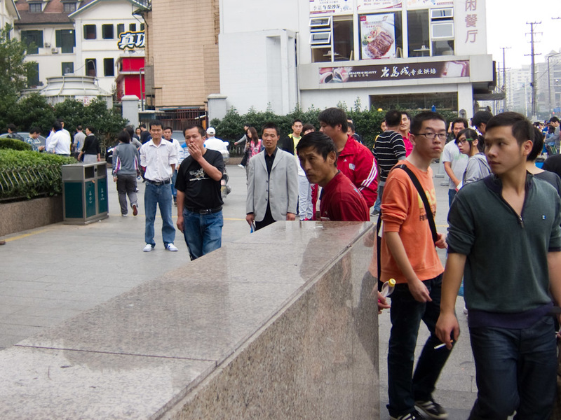 China-Shanghai-Xujiahui-Mall - At the top of every subway exit are guys like this. All of them looking to scam you in some way, generally they want to take you on a shopping tour or