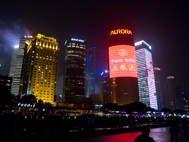 China-Shanghai-Pudong-Beef-Neon - Looking back towards Pudong, the Aurora building and the building to its right have full motion video playing on their full height.