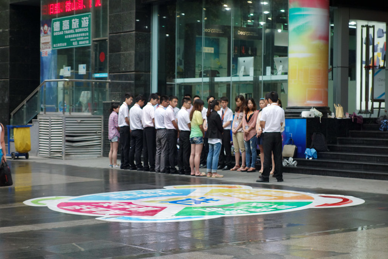 Back to China - Shanghai - Nanjing - Hangzhou - 2012 - On my way to the zoo, store opening time. Out the front of every store the staff pledge allegiance to uphold the honor and principles of selling peopl