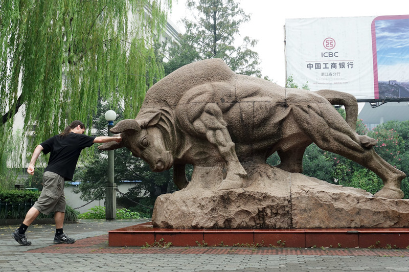 China-Hangzhou-West Lake-Fog - Before I hit the lake, I warmed up by punching this bull square in the head. Check out my calves, im a super hero. 