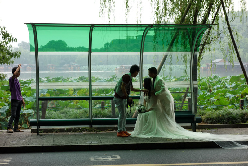 China-Hangzhou-West Lake-Fog - OK, this is a different wedding. But they have decided to have their photos taken in a bus stop. I can only hope the reason is this is where they met,