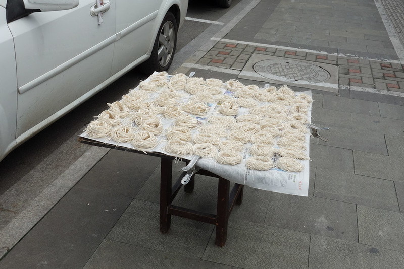 China-Suzhou-Garden-Architecture - Fresh noodles are better than dried. This photo demonstrates why, your noodles may be dried in the street. This adds a delicious concrete dust flavour