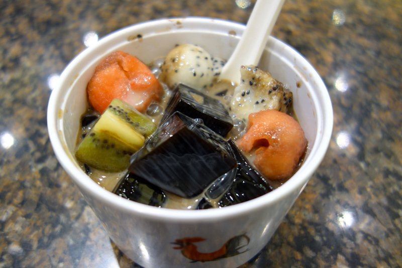 China-Shanghai-Xujiahui - I couldnt eat all my dinner so I thought I would have dessert. Unfortunately this was some nice looking fruit with cubes of grass jelly, which would h