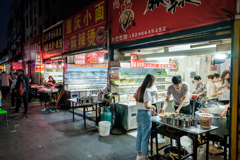 The great loop of China - April 2018 - There are lots of alleyways filled with food carts and little food stands such as this, 3 identical ma la tang shops in a row. They didnt really have 