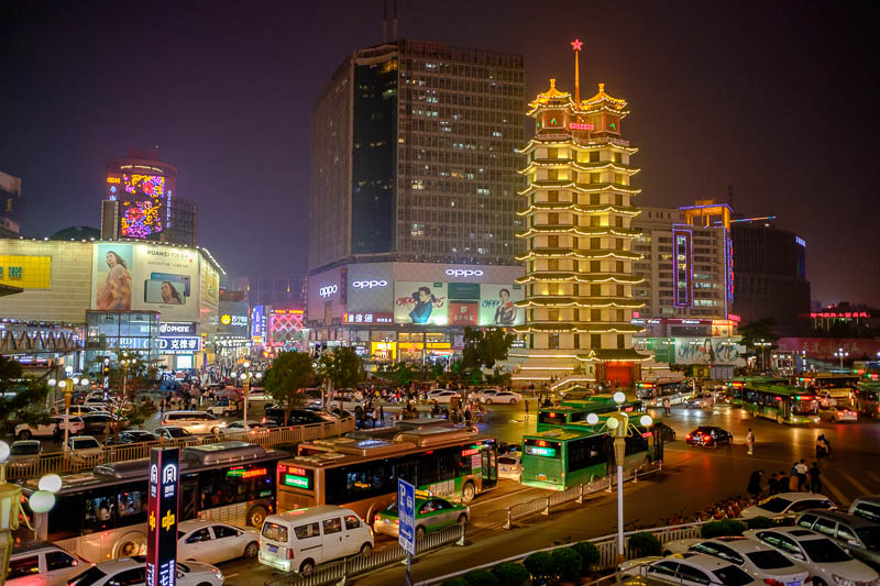 The great loop of China - April 2018 - Here we have the busy Erqi square and tower, looking back towards the old side of town from a road overpass, with all the neon from the pedestrian str