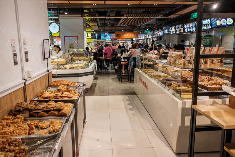 The great loop of China - April 2018 - Next up, the supermarket, notice it not only has a huge bakery, but behind it tables and chairs. They will cook you dinner in here, noodle bars, sushi