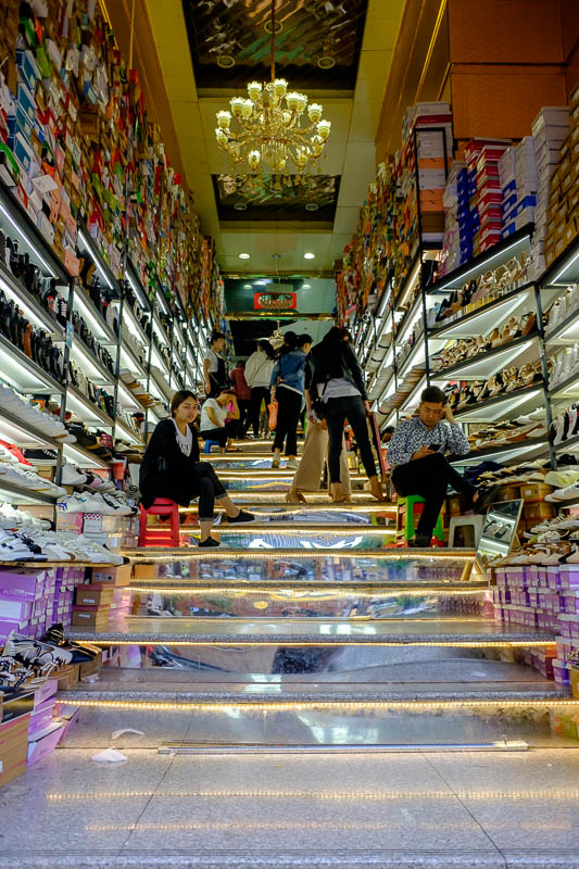 The great loop of China - April 2018 - A store has set up on a staircase leading to another store.