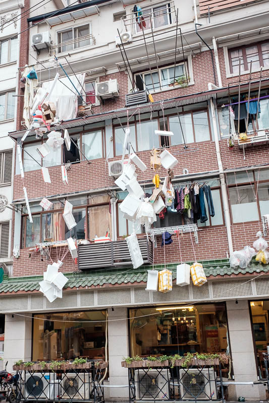 China-Shanghai-Zhujiajiao-Parrot - I am not sure what is going on here, someone has hung various pieces of polystyrene off their window where underpants would normally hang. Art / Rubbi