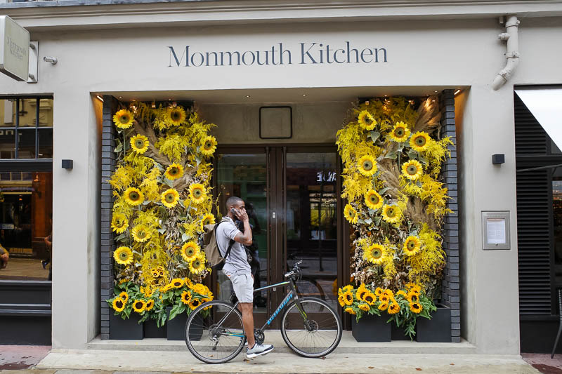 France & England... for work... - Many pubs and shops in London are decorated with similar fake floral displays. This guy is phoning the royal sunflower appreciation association to rep