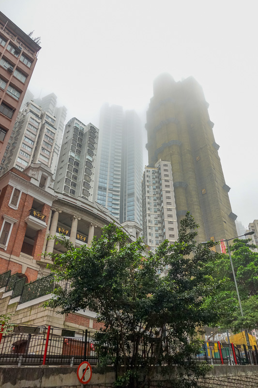 Hong Kong-The Peak-Fog - These buildings always amaze me, they are built on the side of a steep hill, seemingly designed to slide down the water logged slope whenever it next 