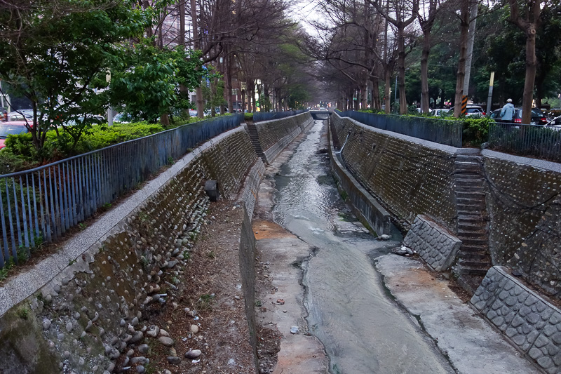 Taiwan-Taichung-Night Market-Fengjia - One of many open drains in Taichung. They try and disguise them as parks, but they smell! I see random pipes of mystery liquid running into them.