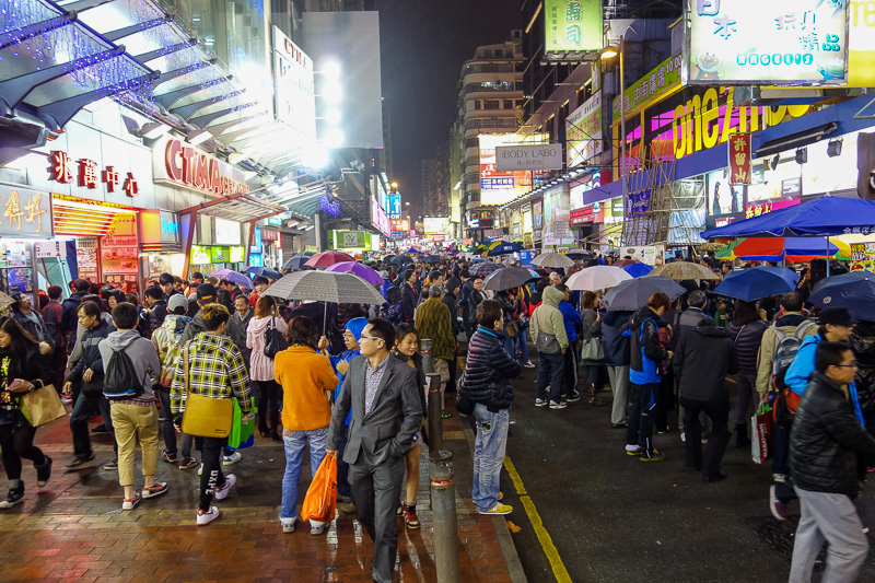 Hong Kong-Mall-Mong Kok - The Mong Kok electronics street that gets closed off every night and fills up with people, buskers, and children paid about $1 to hold cardboard signs
