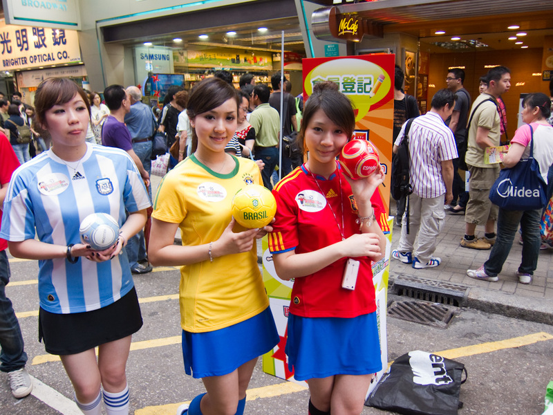 Hong Kong-Mong Kok - Time for some Hong Kong promotions girls, they are very popular amongst the throngs of photographers, these ones advertising the world cup.
