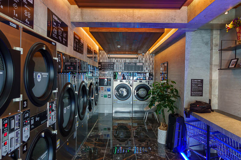 Japan-Hiroshima-Matsuyama-Ferry - After walking for a few hundred metres from the weird private train line, I found a coin laundry. Complete with futuristic blue lighting. Google camer
