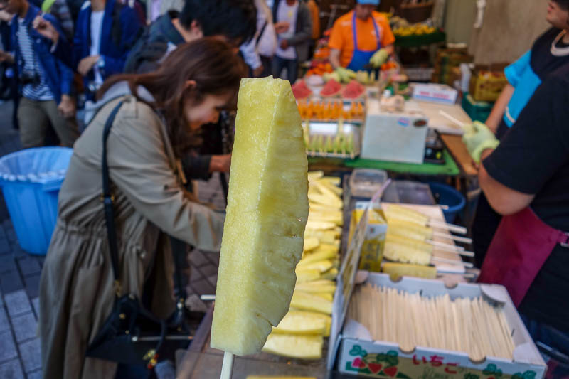 Japan-Tokyo-Ueno-Ameyoko - To keep hunger at bay, I settled for pineapple on a stick, which was actually great. The jar it came out of was enormous.