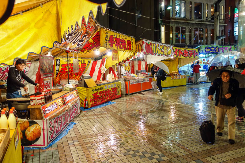 Japan 2015 - Tokyo - Nagoya - Hiroshima - Shimonoseki - Fukuoka - At first I thought these were the only stalls set up, I thought their location was very weird. Look at the people scurrying out of the rain, whilst un