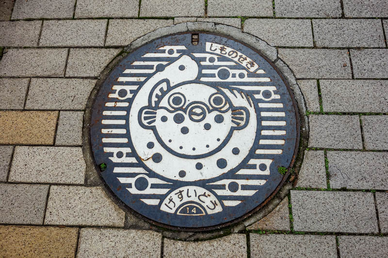 Japan 2015 - Tokyo - Nagoya - Hiroshima - Shimonoseki - Fukuoka - All drain covers in Shimonoseki are of the beloved fuku, that can kill you dead if its prepared wrong. Apparently the city is the only place in the wo