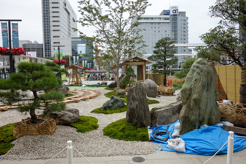 Japan-Nagano-Toyama-Shinkansen - A small garden is being erected out the front of the Toyama station.