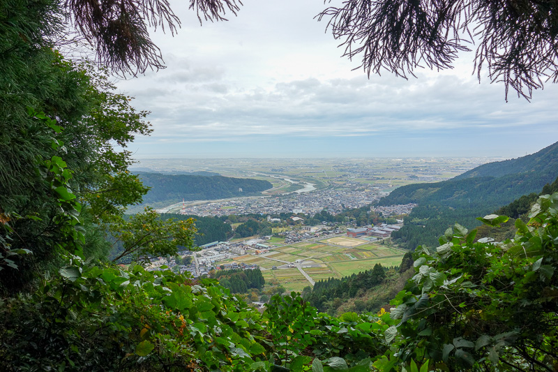 Visiting 9 cities in Japan - Oct and Nov 2016 - Half way up, looking back down the river towards Kanazawa. A very grey day. You can see the ocean and some ships, across the ocean is North Korea.