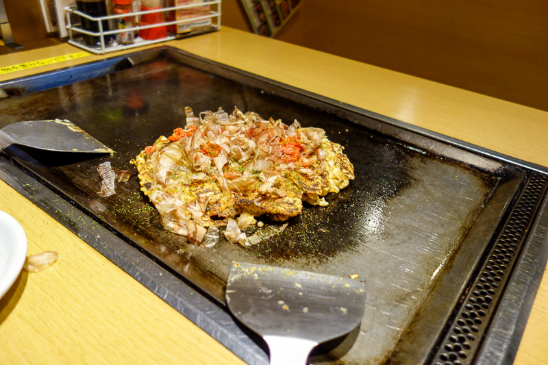 Japan-Sapooro-Mall-Food-Okonomiyaki - Step 3, flip it again and add the other stuff they provide on your table. Bonito flakes, I have no idea what these are, prawn shells perhaps. The good