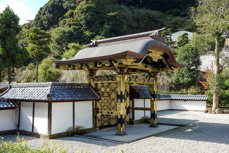 Visiting 9 cities in Japan - Oct and Nov 2016 - Some kind of gold spray painted decorative gate near a money collecting wishing well.