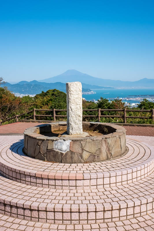 Japan-Shizuoka-Shrine-Kunozan Toshogu-Hiking - The summit marker, lined up with Fuji. The missing tile really bothers me more than it should. I suspect this is where everyone takes a photo, and eve