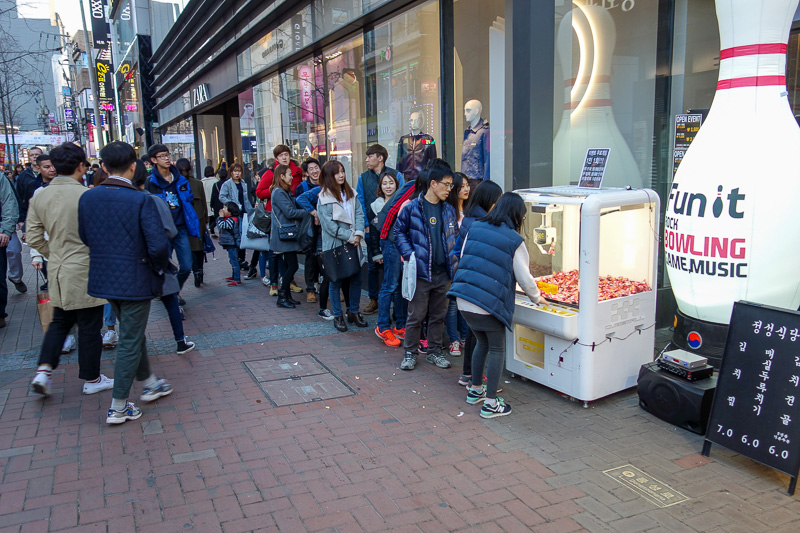 Korea again - Incheon - Daegu - Busan - Gwangju - Seoul - 2015 - Not entirely sure what was going on here, a line of people waiting to try their luck at whatever that skill tester game is doing. When some girls got 
