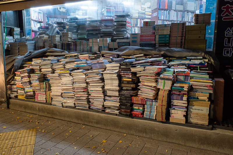 Korea-Seoul-Hongdae - I have seen a few book shops like this. Similar concept to shoe shops. Just pile more of everything everywhere. If it rains, cover it all in a tarp. N