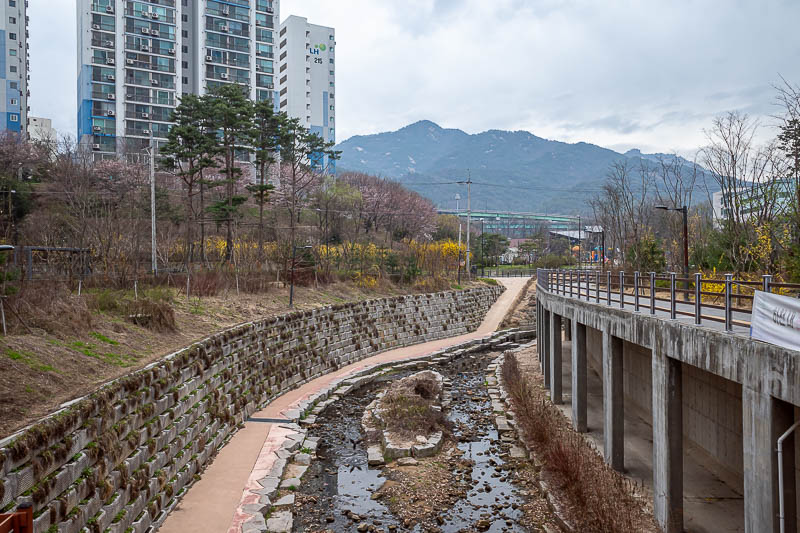 Korea-Seoul-Hiking-Suraksan - There are my mountains for today. They look strangely far away in this photo, despite the trail starting just under those freeway overpasses in the ce