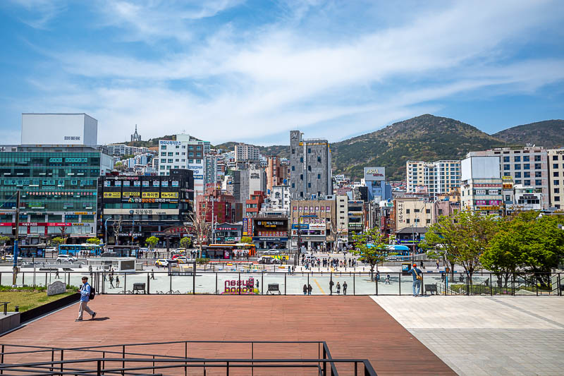 Korea-Gyeongju-Busan-Train - Arriving in Busan to blue sky and shops going up hills in every direction.