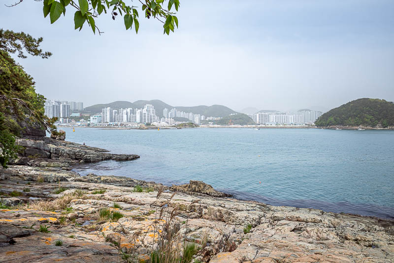 Korea-Busan-Beach-Dadaepo - Rocks plus high rises, and lots of pollution. There is no cloud in this shot, and the camera cleans it up a bit compared to the naked eye.