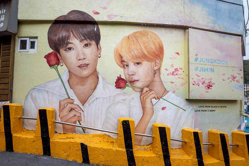 Korea-Busan-Gamcheon-Pollution - Tribute murals of girly men such as these two are also prominent features all around Gamcheon. There was a line, but I snapped my shot during a change