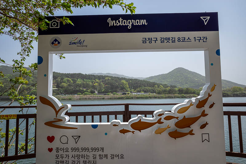 Korea-Busan-Hiking-Hoedong - At the far end of the lake there is a bus stop, cafes, and an instagram advertisement.