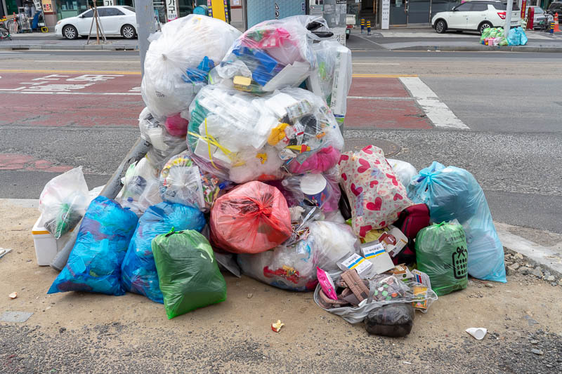 Korea - HK - China - KORKONG! - And just like Japan, Korea has no bins at all, only bags. Piles and piles of bags of garbage on the street at all times. This is how you get a good re