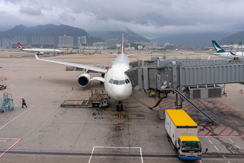 Airport-Hong Kong-Lounge - That is not my plane. It is a Qantas jet, but I took the photo because of those mountains, calling me, shrouded in cloud currently. I will be back in 