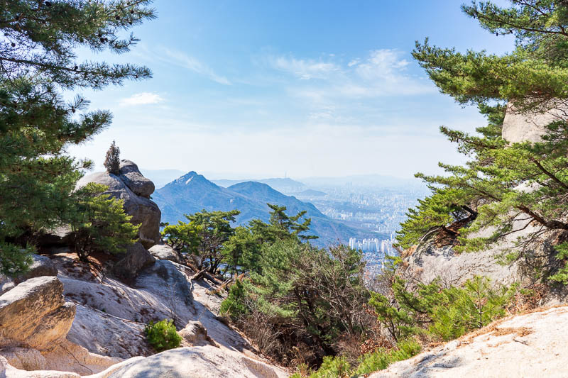 Korea-Hiking-Suraksan - Clearly I was enjoying taking photos of rocks contrasting against pine trees with the city in the background PUNCTUATED by an overly blue sky.