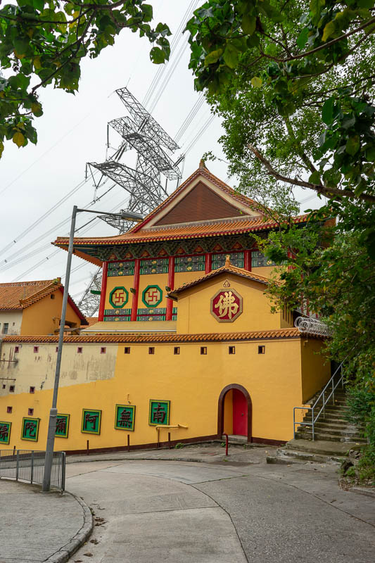 Hong Kong-Hiking-Lion Rock - Last photo, a temple! This one features razor wire, swastikas, and a huge power pole thingy. Soon after this, it started raining hard, literally minut