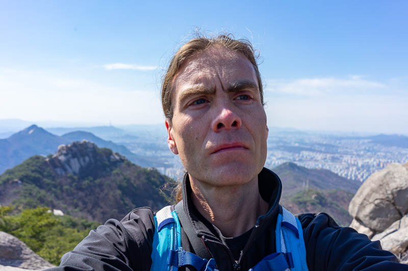 Korea - HK - China - KORKONG! - The lines on my face look particularly deep today. I am starting to look like 90 year old Clint Eastwood. Here you can see my running backpack. I have