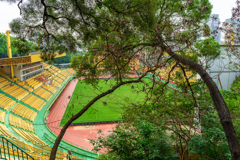 Korea - HK - China - KORKONG! - Descending man made mystery mountain takes you into another garden area, with an old fortress wall I could not find. There is also this sports stadium