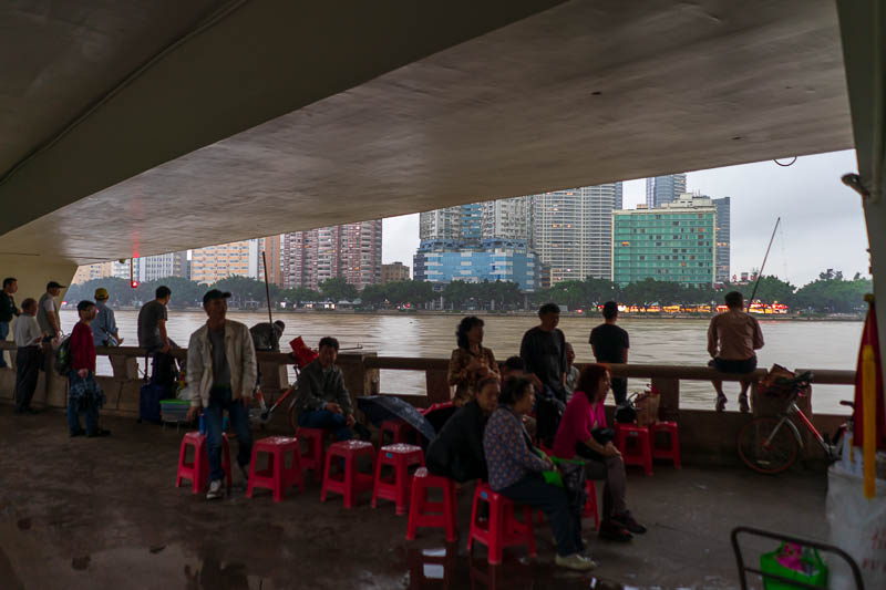 China-Guangzhou-Rain - My safe haven was under a bridge, where old ladies sung, and a couple of guys were fishing. They actually caught fish and were very excited when they 