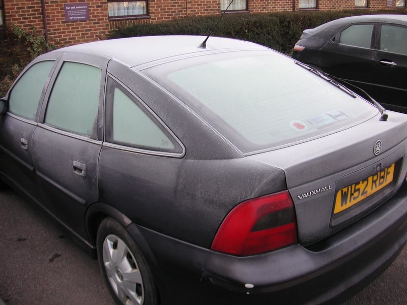 England-Hatfield-London-Frost - Frost on a car, people scrape it off with spatula things
