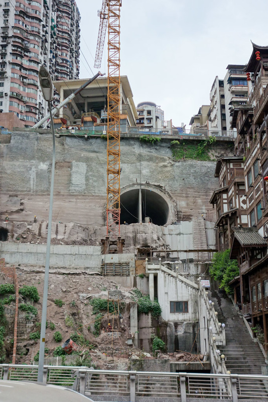 China-Chongqing-Hongyadong - At the top of this picture you can see where the bridge will connect to. A bit further down theres a tunnel which is either a drain or the subway. The