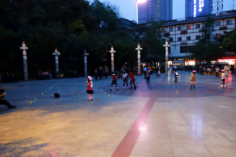 China-Chengdu-Architecture - Nearby is the rollerblading instruction camp, at dusk on Sunday night. The instructor was enthusiastic, charging about screaming his lungs out at the 