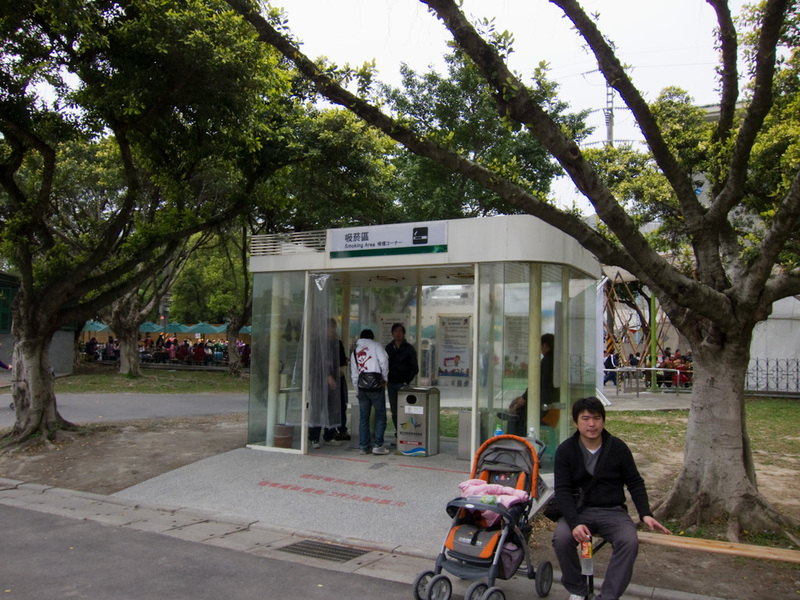 Taiwan-Taipei-Floral Expo-Danshui - All over Taipei you find smoking booths like these. Get into your booth filthy smokers! Smoking is generally banned outdoors as well as in. So they pu