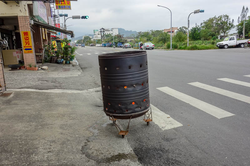 Taiwan-Hualien-Taitung-Train - Everyone, every single store or business, is burning bits of paper in the streets, and has a small table with food on it, mainly fruit but also chocol